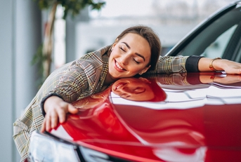 Woman hugging a car
