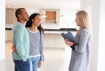 happy Female Realtor Showing Couple new House