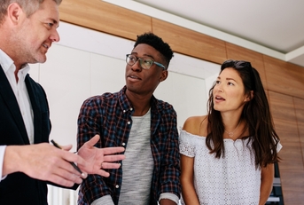Interracial couple consulting realtor