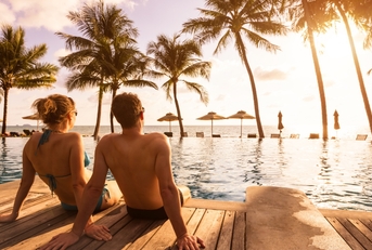 couple enjoying beach vacation at tropical resort 