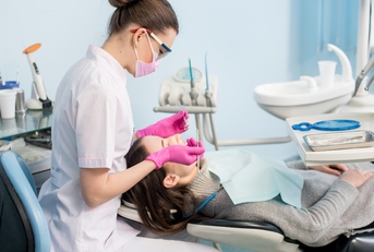 Female dentist with dental tools