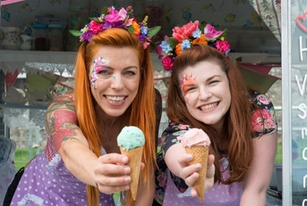 Two ladies holding ice cream from truck