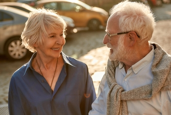 elderly couple holding hands