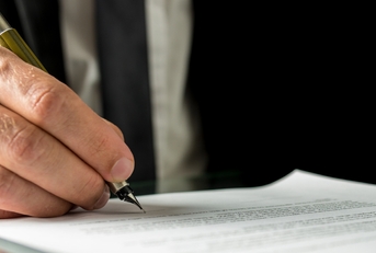 businessman signing a document