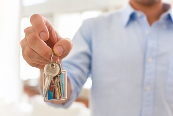 Man holding keys of his house