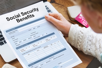 woman reading Social Security Benefits Form Concept