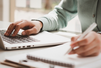 Business women work on computers