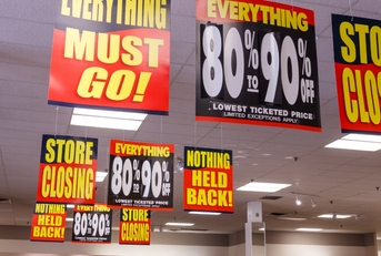 huge discount signs displayed at closing store