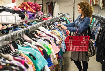 Female Shopper In Thrift Store