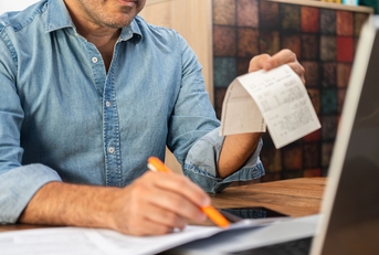 middle-aged man calculating taxes