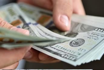 businessman counting banknotes in hand