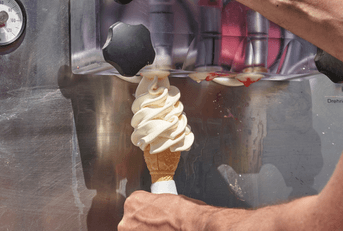 Vanilla ice cream cone and soft serve machine