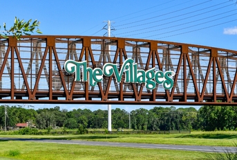 the Villages sign over Steel bridge