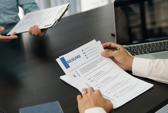examiner reading a resume