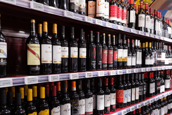 Shelves with wine at beverage section of supermarket