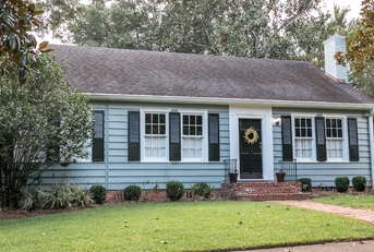 old blue cottage style house with sidewalk