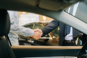 Buyer of car shaking hands