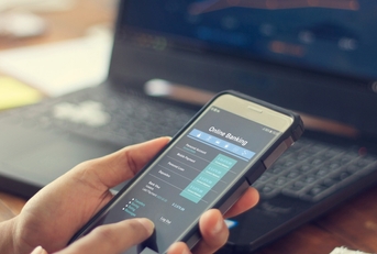 Businessman using online banking services on smartphone
