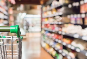 supermarket shopping cart with green handle