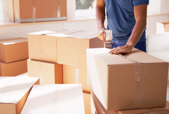 man packing boxes for move
