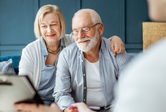 Senior couple signing agreement with finance advisor