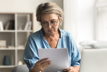 older woman reading document