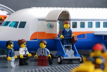 Lego businesspeople minifigures besides private jet