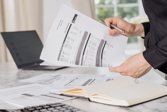 Female holding gas bill