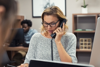 businesswoman talking on phone at office 