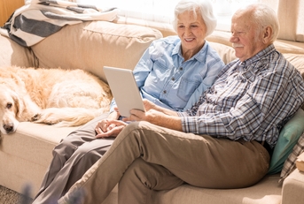 portrait of modern senior couple using laptop