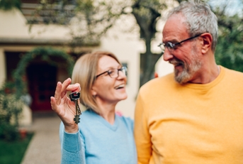 senior couple holding keys