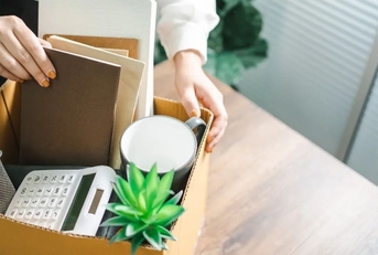Woman packing up belongings at work