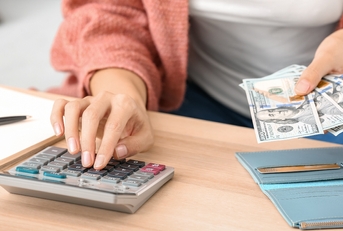 woman counting money at home