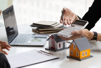 real estate agent holding a calculator