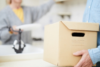 man carrying heavy carton box