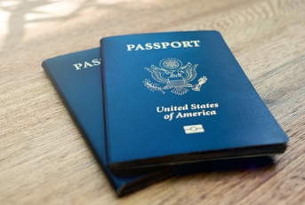 american passports laying on a wooden desk