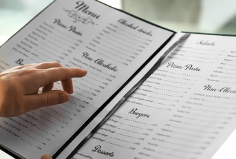 Woman reading menu in cafe