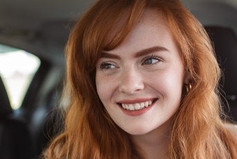 Smiling woman driving a car