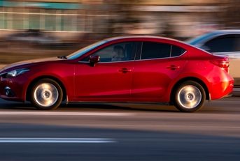 red mazda 3 moving