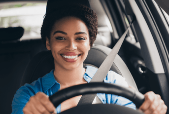 Smiling woman driving a car