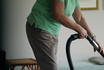 woman cleaning with vacuum 