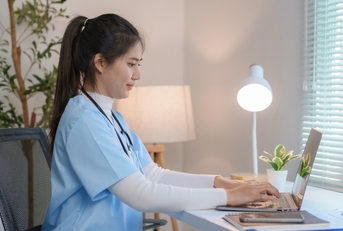 nurse working at home desk