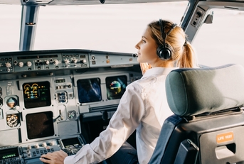 woman pilot sitting in airplane cockpit
