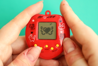 tamagotchi in red plastic case