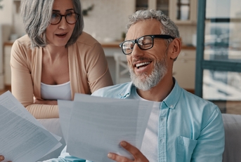 couple in casual clothing taking care of their taxes