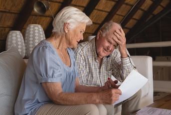 senior couple discussing over medical bills
