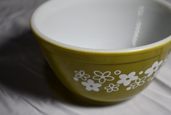 green pyrex bowl on white table cloth