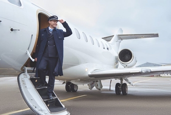 pilot standing on stairs of aircraft