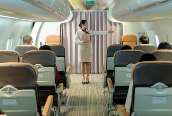 Flight attendant giving safety instructions to passengers