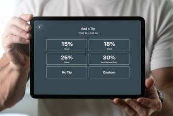 Man holding a tablet with tipping screen